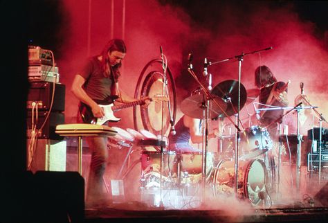 Pink Floyd playing on the stage surrounded with a smoke and illuminated with a red stage lights during the concert at Merriweather Post Pavilion, Columbia, Maryland in 1973. Pink Floyd Songs, Pink Floyd Albums, Pink Floyd Art, Richard Williams, Richard Wright, Alvin Ailey, King Crimson, Brick In The Wall, Pink Floyd Dark Side