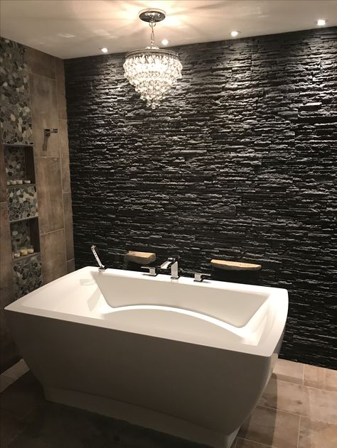 Black Rock Wall Interior, Stacked Stone In Bathroom, Stacked Stone Bathroom Wall, Stacked Stone Bathroom, Black Stacked Stone Fireplace, Dreamscape Bathroom, Black Stone Fireplace, River Rock Bathroom, Cabin Makeover