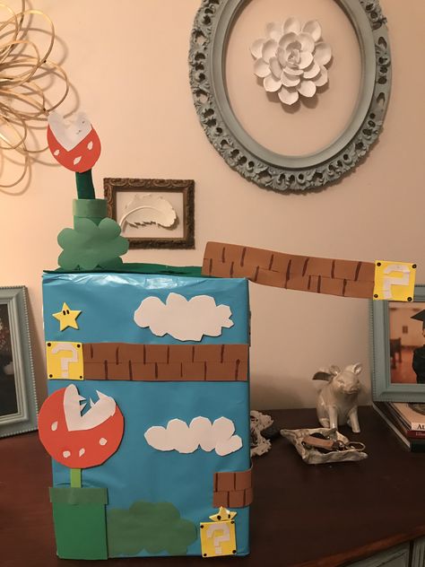 Foam, construction paper, wrapping paper, flower wire, toilet paper roll, boy Valentine’s mailbox Construction Paper Flowers, Flower Wire, Valentine Mailbox, Paper Wrapping, Super Mario Brothers, Mario Brothers, Valentines For Boys, Toilet Paper Roll, Construction Paper