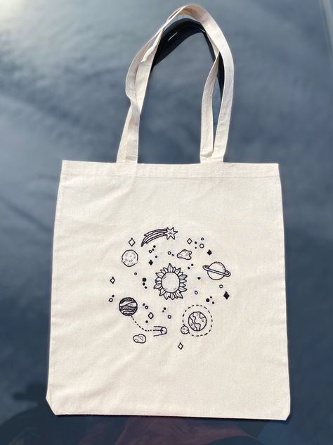 Handmade embroidered tote bag Check out my instagram post Tote Bags Design Ideas, Cute Tote Bag Design, Solar System Kids, Planets Saturn, Decorated Tote Bags, Diy Tote Bag Design, Handpainted Tote Bags, Tote Design, Space Bags