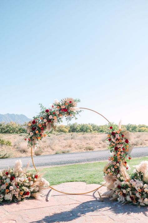 Create a stunning focal point for your wedding ceremony with a metal round arch adorned with vibrant pink and orange flowers. This eye-catching backdrop adds a pop of color and elegance to your special day, making it a picture-perfect moment you'll cherish forever Round Flower Backdrop, Circle Backdrop With Flowers, Round Floral Arch, Vibrant Fall Wedding, Wedding Arch Round, Photoshoot Decor, Round Wedding Arch, Pink Orange Flowers, Albuquerque Wedding