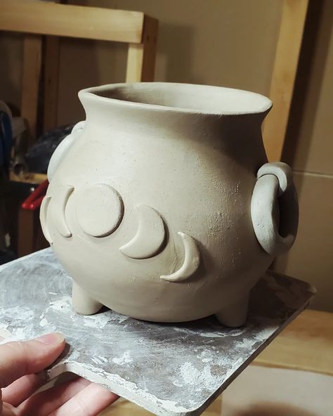 Working on some cauldrons... debating if i should make the one with the side loop handles a planter, or no drain holes and keep it as a bowl... thoughts? What would you use it for.... #handmadeceramic #ceramiclove #collectibleart #coffeeloversclub #coffecup #potterymug #darkacademiaaesthetic #pottery #moonlover #moonphases #cauldron #potterymug #potterymugs #coffeelover #witchy #witch #halloweenlife #halloween #coffeemug #halloweendecor #halloweendecor #halloweenlover #goblincore #goth #got... Witchy Pottery, Goblincore Goth, Skull Ceramics, Goblin Core, Moon Lovers, Dark Academia Aesthetic, Pottery Mugs, Moon Phases, A Bowl