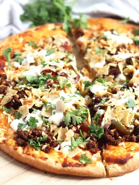 Mix up your pizza nights with this delicious Mexican nacho pizza recipe. Loaded with seasoned ground beef and topped with tortilla chips and all your favorite nacho toppings, this is one delicious piece of pie! Nacho Pizza Recipes, Nacho Pizza, Mexican Nachos, Pizza Nachos, Nacho Toppings, Crispy Pizza, Best Pizza Dough, Make Your Own Pizza, Seasoned Ground Beef