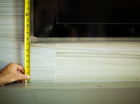 Beyond functional concerns, the height of a flat-panel TV can affect the overall aesthetics of your room. If the TV is placed too low, the mantel will appear cluttered and the fireplace will seem off-balance. To avoid this problem, allow 7 inches of clearance between the top of the mantel and the bottom of the flat-panel TV. This will allow enough room beneath the TV for ventilation, and the negative space will provide a clean, uncluttered canvas for decorative objects. Height Of Mantle Above Fireplace, How High To Mount Tv On Wall Above Fireplace, How High To Mount Tv Over Fireplace, Tv Height Above Fireplace, Mantle Height Above Fireplace, Mounting Tv Above Fireplace, Tv On Top Of Fireplace, Tv Above Mantle, Tv Bookshelves