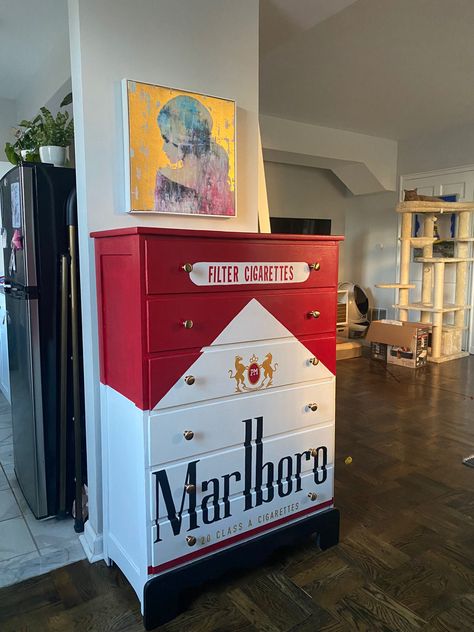 A dresser painted to look like a pack of Marlboro Red Cigarettes Unique Rugs Rectangle, Cool Room Wallpaper, Spicy Room Decor, Weird Aesthetic Room, Graffiti Furniture Ideas, Bar Themed Room, Weird House Decor Diy, Unique Home Furniture, Fun Storage Ideas