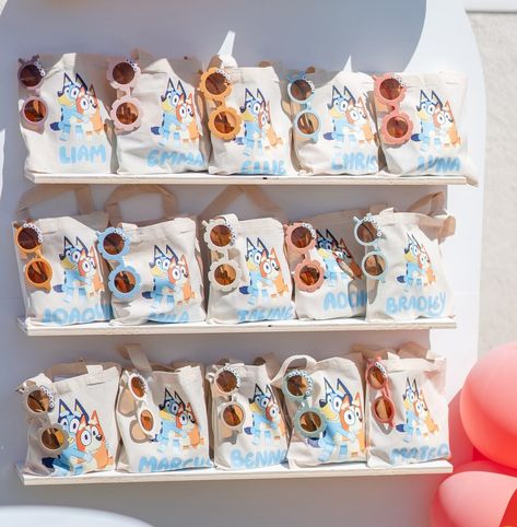 Bluey-themed party favors featuring Bluey characters Bluey Adopt A Floppy, Bluey 1st Birthday Party Ideas Boy, Bluey Party Favors Free Printables, Bluey Daisy Party, Bluey Favor Bags, Bluey Birthday Party Table, Bluey Goodie Bags, Bluey Birthday Favors, Bluey Party Favor Ideas