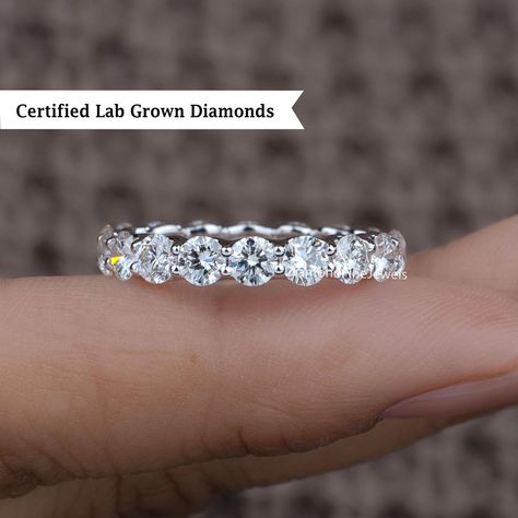 3.5MM Round Lab Diamond Eternity Band, U Shared Prong Round Diamond Wedding Band, Wide Anniversary Band, Bridal Matching Band Christmas Gift ● 𝐃𝐢𝐚𝐦𝐨𝐧𝐝 𝐃𝐞𝐭𝐚𝐢𝐥𝐬: ➢ Shape: Round Cut ➢ Diamond Type: Lab Grown Diamond ➢  Color: EF ➢  Clarity: VS ➢ Carat: 3 TCW apx 𝐀𝐥𝐥 𝐥𝐢𝐬𝐭𝐞𝐝 𝐫𝐢𝐧𝐠 𝐚𝐫𝐞 𝐦𝐚𝐝𝐞 𝐚𝐬 𝐚 𝐜𝐮𝐬𝐭𝐨𝐦 𝐨𝐫𝐝𝐞𝐫, 𝐚𝐧𝐝 𝐡𝐞𝐧𝐜𝐞, 𝐭𝐡𝐞 𝐦𝐞𝐚𝐬𝐮𝐫𝐞𝐦𝐞𝐧𝐭𝐬 𝐨𝐫 𝐜𝐚𝐫𝐚𝐭 𝐰𝐞𝐢𝐠𝐡𝐭 𝐜𝐚𝐧 𝐝𝐢𝐟𝐟𝐞𝐫 𝐬𝐥𝐢𝐠𝐡𝐭𝐥𝐲 𝐝𝐞𝐩𝐞𝐧𝐝𝐢𝐧𝐠 𝐨𝐧 𝐭𝐡𝐞 𝐚𝐯𝐚𝐢𝐥𝐚𝐛𝐢𝐥𝐢𝐭𝐲 𝐨𝐟 𝐝𝐢𝐚𝐦𝐨𝐧𝐝𝐬. 𝐅𝐨𝐫 𝐦𝐨𝐫𝐞 𝐝𝐞𝐭𝐚𝐢𝐥𝐬, 𝐟𝐞𝐞𝐥 𝐟𝐫𝐞𝐞 𝐭𝐨 𝐜𝐨𝐧𝐭𝐚𝐜𝐭 𝐮𝐬. ● 𝐂𝐞𝐫𝐭𝐢𝐟𝐢𝐜𝐚𝐭𝐢𝐨𝐧 We do provide Jewelry Certificate on request. It is chargeable Service. Please contact us via massage for more information. ● 𝐂𝐚𝐧𝐜𝐞𝐥𝐥𝐚𝐭𝐢? Round Diamond Wedding Band, Band Christmas, Round Diamonds Wedding Band, Jewelry Certificate, Diamond Eternity Band, Diamond Eternity, Matching Band, Diamond Wedding Band, Anniversary Bands