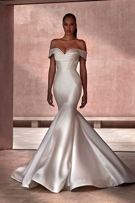 A refined version on the traditional mermaid gown in Mikado, with a stunning ruffled skirt and a smoldering off-the-shoulder effect. The Avonia gown exemplifies design creativity and uniqueness. Mikado Wedding Dress, Kleinfeld Bridal, Mermaid Silhouette, Mermaid Gown, Marchesa, Bridal Shop, Mermaid Dresses, Ruffle Skirt, Pregnant Women