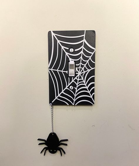 These are 3D-printed light switch covers, designed by me!  They are all made to order so allow up to 2 weeks of processing time. They're made from PLA, with several colors available!   :) The color shown in the photos is BLACK. All webs are WHITE you are picking one color for the background and spider. These are your average light switch cover, so please make sure they will fit in your space before you buy them!  They fit any standard single-gang toggle light switch cover. They measure about 4.7 Painting On Light Switch, Light Switch Decoration, Halloween Light Switch Covers, Lightswitch Ideas Painting Easy, Gothic Light Switch Covers, Light Switch Painting Ideas Aesthetic, Painted Lightswitch Cover, Diy Lightswitch Cover Ideas, Light Cover