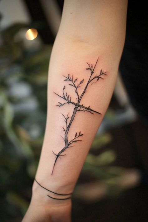 A forearm with a delicate tree branch tattoo, featuring thin lines and small leaves. Biblical Plant Tattoos, Biblical Nature Tattoos, Cross And Vine Tattoo, Christian Vine Tattoo, Unique Biblical Tattoos, Christian Female Tattoos, Waymaker Tattoo, Nurse Tattoos For Women, Cross With Crown Of Thorns Tattoo