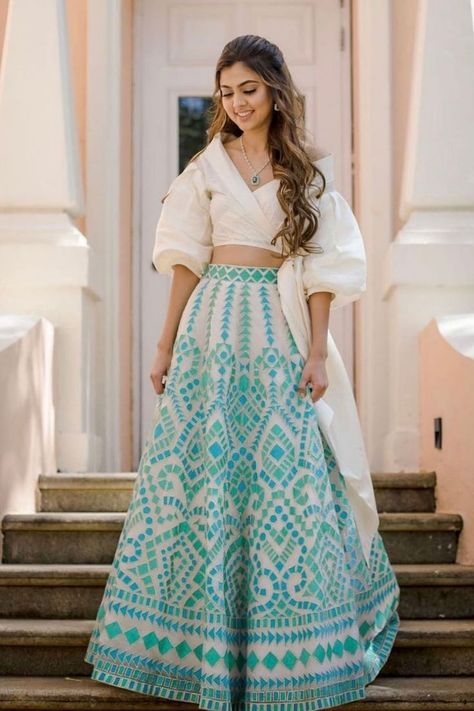 Your wedding is soon approaching, and so is the time to pick the most charismatic outfit for various wedding functions. Sangeet is one glorified wedding function in every Indian wedding. Today, Indian brides are going for options like Dhoti saree, peplum with a skirt, crop top with a skirt, and more. Take a look at this list of the most trending and glamorous sangeet outfits of 2021 to flaunt your charisma in style. Lehenga Choli For Women, Crop Top Lehenga, Sangeet Outfit, Choli For Women, Trendy Outfits Indian, Mehendi Outfits, Party Wear Lehenga Choli, Lehenga Designs Simple, Lehenga Blouse Designs