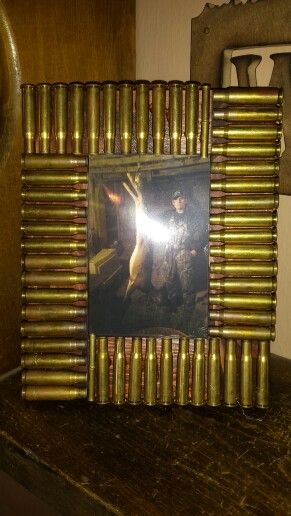 Bullet casing picture frame. I  bought a 4x6 frame from the craft section at walmart and we had some stain left over from doing our bathrooms. Then I had my husband save his shells for me. Add a little hot glue and done! Shotgun Shell Art, Shell Casings Crafts, Bullet Casing Crafts, Shotgun Shell Crafts, Hunting Crafts, Bullet Crafts, Bullet Art, Simply Life, Bullet Shell