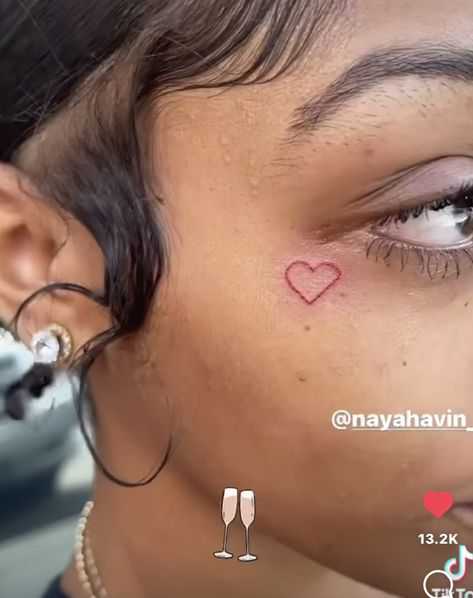 Heart Face Tattoo Black Women, Red Heart On Face Tattoo, Heart Tattoo On Face Black Women, Red Heart Face Tattoos For Women, Red Heart Face Tat, Pink Heart Face Tattoo, Small Red Face Tattoos For Women, Small Heart Tattoo On Face, Black Women Face Tattoos