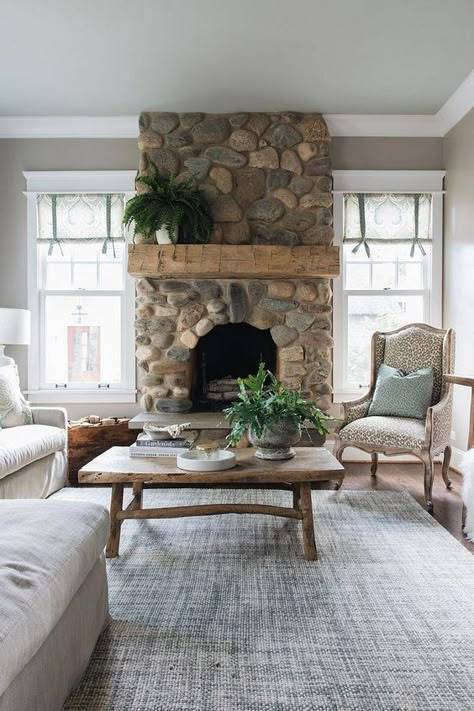 a refined vintage living room with a river rock fireplace that brings a touch of nature to the space River Rock Fireplace, Best Benjamin Moore Paint Colors, River Rock Stone, Beam Mantel, Design Camino, River Rock Fireplaces, Rock Fireplace, Benjamin Moore Paint Colors, Farmhouse Style Bedrooms