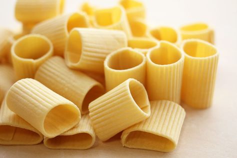 Rigatoni Rigatoni are a form of tube-shaped pasta of varying lengths and diameters originating in Italy.They are larger than penne and ziti, and sometimes slightly curved, though nowhere near as curved as elbow macaroni. Rigatoni characteristically have ridges down their length, sometimes spiraling around the tube. And unlike penne, rigatoni's ends are cut square (perpendicular) to the tube walls instead of diagonally. Tube Pasta, Shaped Pasta, Elbow Macaroni, The Tube, Rigatoni, Macaroni, In Italy, Pasta, Italy