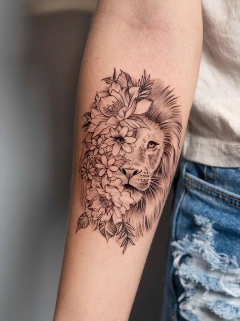 Why not try lion tattoos for your next tattoo design? Lions are one of the most popular tattoo designs for men because they represent dominance, strength, confidence, and courage. They are called kings of the jungle for no reason. They are also instantly recognizable, which means they are suitable for many different artistic styles-from realism to geometric and tribal. Read on, and you will find all the different types of lion tattoos for women and the one that suits you best. Lion With Sunflower Tattoo For Women, Tattoo Ideas Strength Inspiration, Powerful Lion Tattoo, Meaning Of Lion Tattoo, Lion Back Tattoos For Women, Leo The Lion Tattoos, Womens Strength Tattoo Ideas, Womens Lion Tattoo, Tattoos Of Strength For Women