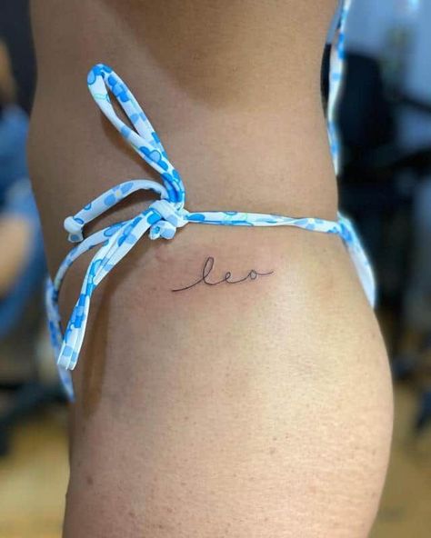 Leo Tattoo On Finger, Mini Leo Tattoo, Leo Cursive Tattoo, Leo Name Tattoo Ideas, Cute Small Leo Tattoos, Leo Name Tattoo, Dainty Leo Tattoos, Subtle Leo Tattoo, Leo Word Tattoo