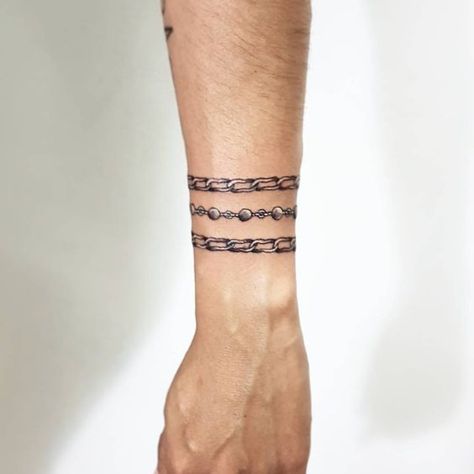 Chain Tattoos on Arm. Chain Tattoos, Universal Tattoo, Arm Cuff Tattoo, Tattoos On Arm, Bracelet Tattoo For Man, Name Tattoos On Arm, Piercing Art, Wrap Around Wrist Tattoos, Wrist Band Tattoo