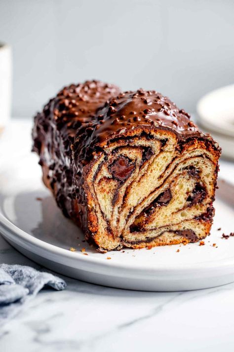 Chocolate Babka is a gorgeous, sweet braided bread. It's buttery, soft, and filled with chocolate. Perfect for holidays and celebrations. It is perfect for a crowd, this recipe makes two babkas and serves 16 people. It is also easy to keep at room temperature and easy to freeze. #jernejkitchen #babka #chocolatebabka #christmas #hannukah #baking #chocolate Babka Recipe, Chocolate Babka, Baking Chocolate, Braided Bread, Blanched Almonds, Chocolate Glaze, Cinnamon Powder, Chocolate Cinnamon, How To Make Chocolate