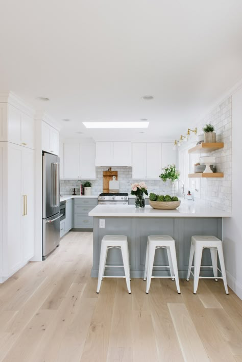 White Cabinets Kitchen Light Floors, Quartz For White Kitchen Cabinets, Kitchen With Connected Island, Light Blue Lower Cabinets White Upper, Dual Tone Kitchen, Dual Tone Kitchen Cabinets, Small Kitchen Makeovers, Grey Floors, Brass Lights