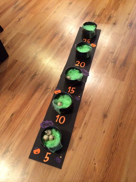 I created this "eyeball toss" game for my daughters halloween birthday party using a foam board, cauldrons from the dollar store and green webbing. I added the numbers and embellishments using my Cricut machine (Create a Critter 2 and George cartridges). We actually used miniature skulls instead of eye balls to toss. Kids had lots of fun! Halloween Punch Out Board, Harvest Halloween Party Ideas, Diy Cardboard Halloween Games, Halloween Ball Toss Game, Halloween Punch Board Game, Monster Mash Party Games, Halloween Yard Games, Halloween Ring Toss, Decor Ideas Birthday