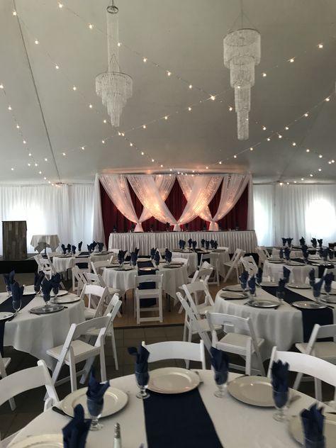 Burgundy Crinkle Desiree Backdrop in the Norland Garden Tent  #lethbridgeeventrentals #lethbridgeevents #backdrop #twinklights #headtable #gardentent #gardenvenue #wedding #weddingreception #burgundy #navy Navy Blue Wedding Tables, Burgundy Wedding Reception, Wedding Reception Head Table, Reception Head Table, Navy And Burgundy Wedding, Garden Tent, Garden Venue, Wedding Tent, Navy Blue Wedding