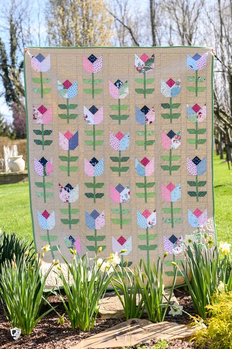 I’m excited to introduce you to my newest quilt pattern, tailored tulips.  The Tailored Tulips quilt pattern is a pre-cut-friendly tulip quilt pattern made using a 10-inch precut or layer cake of fabric and some yardage. Tulip Quilt Pattern, Quilts Using Fat Quarters, Tulip Quilt, Polka Dot Chair, Mug Rug Patterns, Baby Quilt Pattern, Spring Quilts, Half Square Triangle Quilts, Flower Quilts