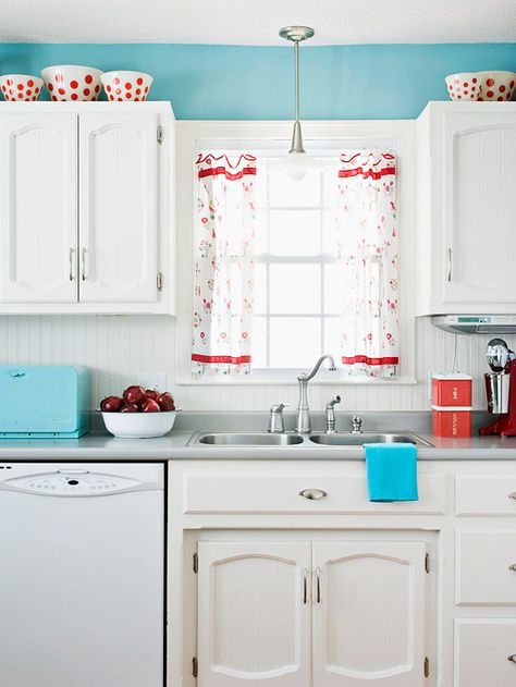 Hints of bright red and sky blue keep this white kitchen feeling fresh. More low-cost cabinet makeovers: http://www.bhg.com/kitchen/cabinets/makeovers/low-cost-kitchen-cabinet-makeovers/?socsrc=bhgpin052913blueandred=7 Low Cost Kitchen Cabinets, Ugly Kitchen, Turquoise Kitchen Decor, Aqua Kitchen, Paint Decor, Retro Kitchens, Victorian Renovation, Pastel Kitchen, Turquoise Kitchen