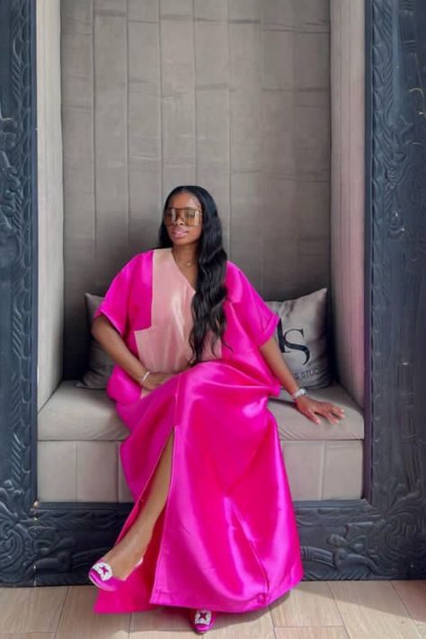 A lady wearing a pink bubu with slit Pink Bubu Gown Styles, Trendy Bubu Gown Styles, Buba Gown Styles, Trendy Birthday Outfits, Mikado Bubu, Latest Bubu Gown Style, Mikado Silk, Bubu Styles, Kaftan Wedding