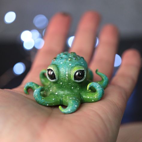 This adorable handmade octopus figurine was hand sculpted in clay, hand painted, and sealed with several layers of a protective varnish. There is glass caviar embedded in its head and a couple of little crater details. This small sculpture measures about 2 inches at the widest length, making it a nice little gift for someone who needs a desk buddy to keep the company while they work. Figurines arrive packed neatly, ready for gifting. Receipts are not included, unless requested.