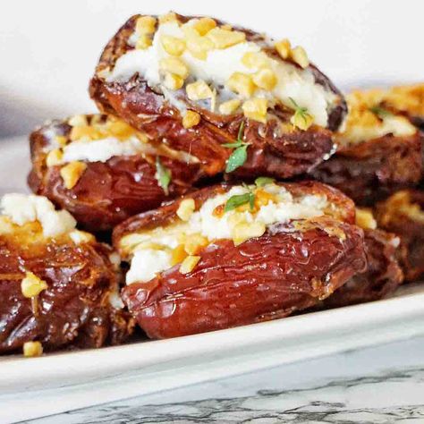 Goat Cheese Stuffed Dates are quick and easy to make! With a simple method we stuff the dates then oven bake them to perfection. Baked Figs With Goat Cheese, Roasted Goat Cheese Stuffed Dates, Cream Cheese Stuffed Dates Recipes, Dates Stuffed With Blue Cheese, Goat Cheese Filled Dates, Dates Stuffed With Cream Cheese, Almond Joy Stuffed Dates, Baked Dates With Goat Cheese, Stuffed Dates With Goat Cheese