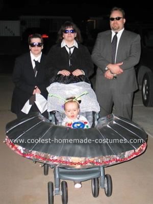 Men in Black Costume: For our son's first Halloween (2006), he had an NG tube due to a health issue.  We decided to incorporate it into our Halloween costume and made him an Stroller Costume Ideas, Family Group Halloween Costumes, Stroller Costume, Group Halloween Costume Ideas, Family Costume Ideas, Costume Ideas For Kids, Costume Ideas For Halloween, Alien Costume, Homemade Costume