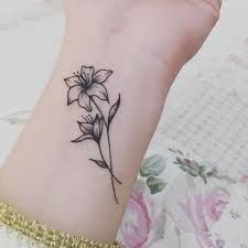 15+ Delicate Narcissus Flower Tattoo Design Ideas – EntertainmentMesh Small Lily Tattoo, Narcissus Tattoo, Lilly Tattoo Design, Lilly Flower Tattoo, Stargazer Lily Tattoo, Narcissus Flower Tattoos, Tiger Lily Tattoos, Lillies Tattoo, Side Wrist Tattoos