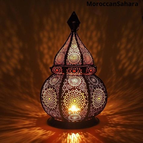 Moroccan style lamps are popular advice from many designers around the world due to their interesting and exotic design and the way these lamps can be linked to everything. It doesn't matter if it's in the salon, room, or nursery. This oriental candlelight looks great everywhere. Distinctive lighting effects add a warm evening touch. An eastern Moroccan scheme to change the room into an Arabian Nights room. The Moroccan lamp supports candles and electric lighting (both not included). You can emb Indian Lamps Decor, Turkish Table Lamp, Persian Lamp, Morocco Lamp, Arabian Bedroom, Morrocan Lamps, Arabic Lantern, Turkish Lanterns, Middle Eastern Decor