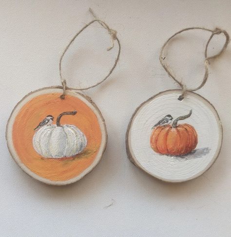 Wood slice ornaments for fall - one with orange pumpkin and chickadee on white background and one with white pumpkin on orange background. Fall Wood Slice Painting, Wood Slice Fall Crafts, Fall Wood Slice Ornaments, Fall Pumpkins Painting, Pumpkin Ornaments, Easter Paintings, Hand Painted Pumpkin, Wood Slice Art, Halloween Wood Crafts