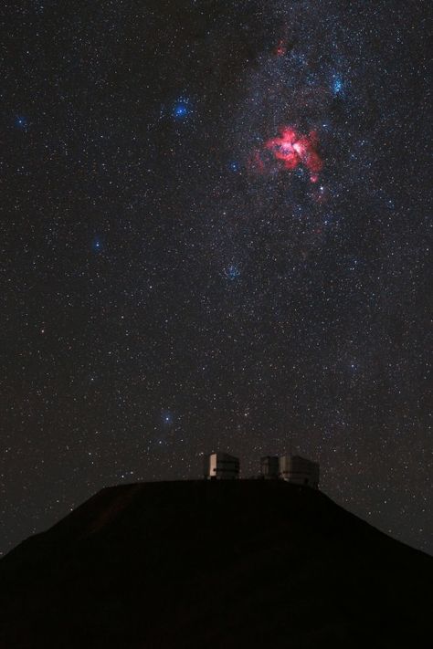 The Eta Carinae Nebula, a bright emission nebula, gives off a fiery red glow above Cerro Paranal and the VLT platform. Taken during the ESO Ultra HD Expedition. Credit: ESO/B. Tafresh Eta Carinae Nebula, Scorpius Constellation, Emission Nebula, Eta Carinae, The Milky Way Galaxy, Largest Telescope, Star Clusters, Carina Nebula, Star System