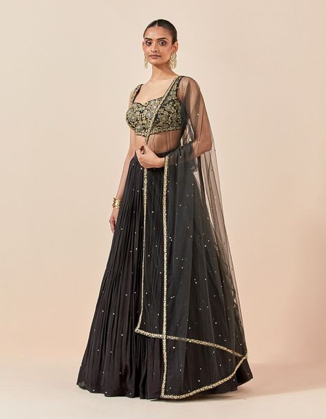 A lehenga set re-imagined for comfort and the celebration season vibes- this black lehenga brings you the charm of intricate hand embroidery that goes well with any occasion. As the first day of romance, this lehenga set is in full bloom with the voluminous lehenga skirt and beautifully done choli. This 3-piece set showcases a minimalistic charm attracting the purveyors of the "less is more" aesthetic.. Product Details. Color: Black. Work: Hand Embroidery. Style: Lehenga Set. Skirt Fabric: Crepe. Blouse Fabric: Chanderi Silk. Dupatta Fabric: Net