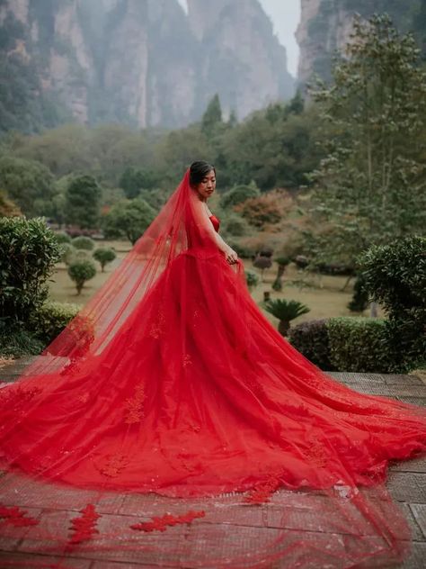 Bride wearing dramatic red ball gown wedding dress with red veil Zhangjiajie China, Vail Bride, Chinese Wedding Dress Traditional, Red Veil, Traditional Chinese Wedding, Zhangjiajie, Red Wedding Dress, Chinese Wedding Dress, Red Wedding Dresses