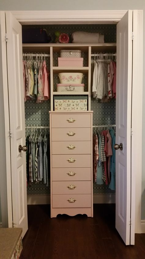 Kaylees finished closet. First I wallpapered the walls with sticky paper from walmart used to line drawers (so much cheaper than wallpaper), then I put her tall dresser in there and built up shelves above it. Added 4 rods and voila! Organization heaven! Love the way it turned out! Clothes Storage Without A Closet, Small Dresser For Closet, Small Space Clothing Storage, Tiny Closet Organization, Small Closet Organization Bedroom, Closet Dresser, Closet Organizer With Drawers, Dresser In Closet, Small Closet Space