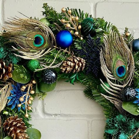 Laura Storrs on Instagram: "‘Pops’ peacock 🦚 feathers are always a hit at Christmas 🎄 #christmaswreath #colourfulchristmas #christmasinspiration #xmaswreath #wreath #peacock #peacockfeathers #peacockchristmas #peacockart #teal #navychristmas #navy" Wreaths With Peacock Feathers, Wreath Peacock, Peacock Feather Wreath, Peacock Christmas, Navy Christmas, Feather Wreath, Peacock Art, Xmas Wreaths, Peacock Feathers