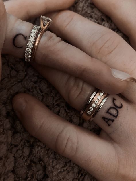 Initial Ring Tattoo, Initial Tattoo On Ring Finger, Initals Tattoo On Finger, Tattoo Ring Finger Initials, Initial Finger Tattoo Wedding Bands, Initals Tattoo On Ring Finger, Marriage Tattoos Ring Finger Initial, Couple Ring Finger Tattoos, Ring Finger Tattoos