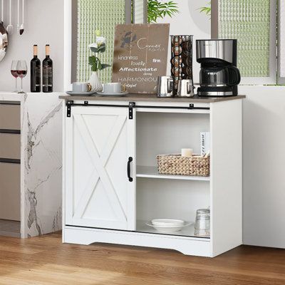 Features:This white coffee bar cabinet combines a perfectly modern style with a farmhouse design. This buffet storage cabinet is featuring a sliding barn door and rustic wood vintage color. If you want to add more farmhouse flavor to your home, this farmhouse barn door buffet coffee bar cabinet will be a great choice. This farmhouse coffee bar cabinet can blend easily all kinds of decor rooms. If you are a coffee-obsessed and cup-collecting lover, this farmhouse sliding barn door coffee bar cabi Farmhouse Coffee Station, Dining Room Buffet Cabinet, Farmhouse Buffet Cabinet, Bar Cabinet Design, Grey Farmhouse, Coffee Bar Cabinet, Living Room Storage Cabinet, Farmhouse Buffet, Farmhouse Coffee Bar