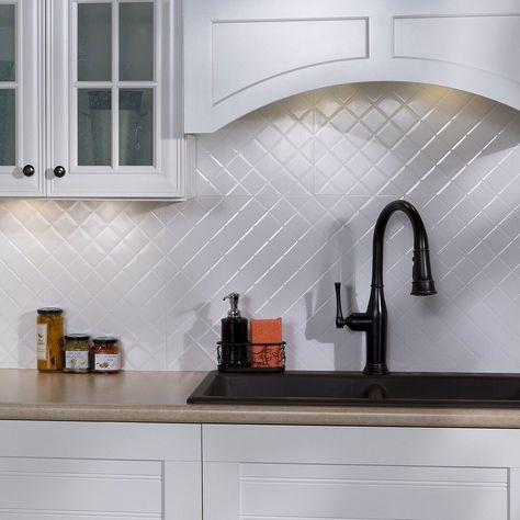 Brighten your kitchen space with the help of this gloss white backsplash kit by Fasade. Made from vinyl material, these tiles are resistant to heat of stovetops and the humidity around your kitchen sink. This backsplash kit is easy to cut to accommodate various shapes and create a complete custom look. Dimensions (overall): 18.25 inches x 24.25 inches x 0.028 inches Color: Gloss White Material: Vinyl (PVC) Samples are random 6 x 6-inch portions of a full panel and do not have the overlapping cap Kitchen Backsplash Panels, Decorative Tile Backsplash, White Gloss Kitchen, White Kitchen Backsplash, White Tile Backsplash, Backsplash Panels, Stone Backsplash, Kitchen Backsplash Designs, White Backsplash