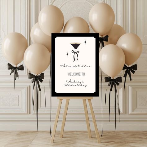 Welcome guests in style with this Editable A Tini Bit Older Welcome Sign Template, perfect for a chic 30th Birthday! This Bow Coquette design adds flair to any Espresso Martini Theme Birthday Party Decor. 𝑵𝑶𝑻𝑬: 𝑨𝒍𝒍 𝒕𝒆𝒙𝒕 𝒊𝒔 𝒆𝒅𝒊𝒕𝒂𝒃𝒍𝒆. 𝑮𝒓𝒂𝒑𝒉𝒊𝒄𝒔 𝒂𝒓𝒆 𝒏𝒐𝒕. 🖤 𝑯𝑶𝑾 𝑫𝑶𝑬𝑺 𝑰𝑻 𝑾𝑶𝑹𝑲? 🖤 Once purchased, you will receive a link to a PDF, which will include your template and instructions for printing and customizing in Canva. Canva is a free (and easy-to-use) platform and I walk you through how to make simple changes to the template. Once edited, you can download and print anywhere you would like. 🖤 𝑾𝑯𝑨𝑻 𝑾𝑰𝑳𝑳 𝑰 𝑹𝑬𝑪𝑬𝑰𝑽𝑬? 🖤 In the PDF you will receive: ❤ Basic instructions ❤ Link to 16x20 template ❤ Link to 18x24 template ❤ Link to 24x36 temp Espresso Themed Party, Bow Themed Party Decor, Audrey Hepburn Party Theme, Espresso Martini Party Decor, Dirty 30 Martini Party, Paris Decorations Party, Martini Birthday Party, Coquette Door, Espresso Martini Themed Birthday Party