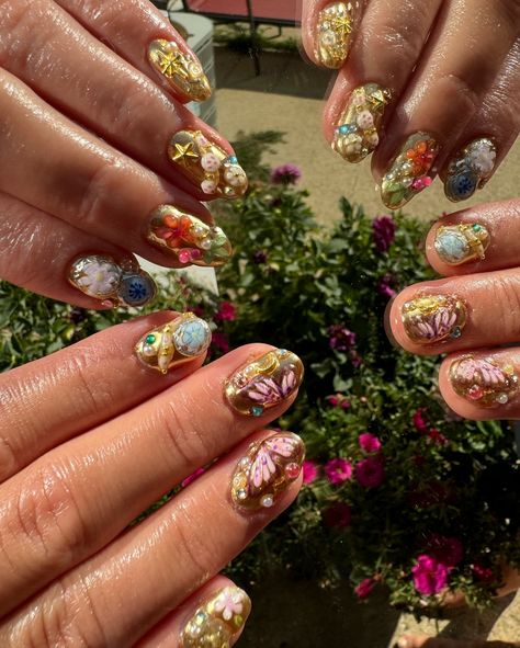 Charm bracelet nails 💎🐚 🔮🌺 . . . #nails #nailinspo #charmbraceletnails #goldnails #charmnails #nailsnailsnails Cherry Jewel Nails, Chaunlegend Nails, Junkyard Nails, Candy Nail Charms, Rose Nail Charm, Junk Nails, Gold Nails, Nail Inspo, Charm Bracelet