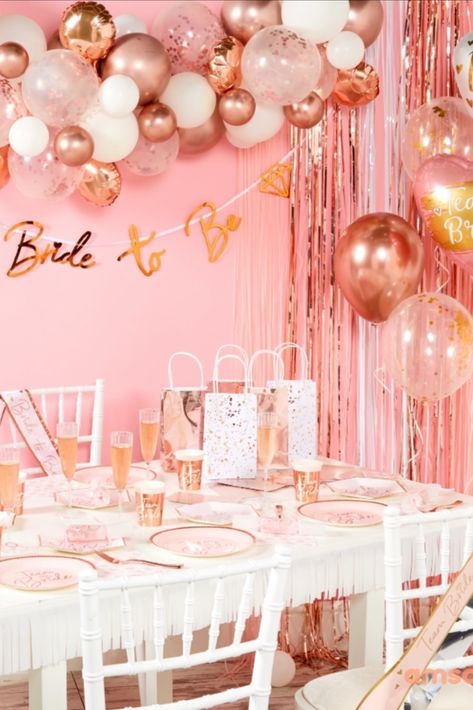 Hen's night party table, with paper plates, cups, gift bags and champagne glasses.

Above is a rose gold balloon garland with a bride to be hanging banner. Hens Night Decorations, Hen Party Decorations, Balloon House, Hens Party, Hens Night, Hen Do, Team Bride, Night Party, Hen Party