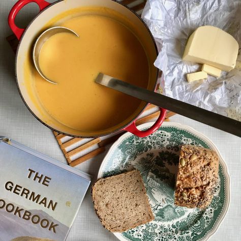 A flatlay of a pan of pumpkin soup, some sliced bread on a green and white plate, a pat of butter and a large cookbook German Christmas Desserts, White Asparagus Recipes, Dinner Party Starters, Festive Bread, Bread Dumplings, Creamy Mustard Sauce, Perfect Mashed Potatoes, Pumpkin Soup Recipe, Meatless Dinner