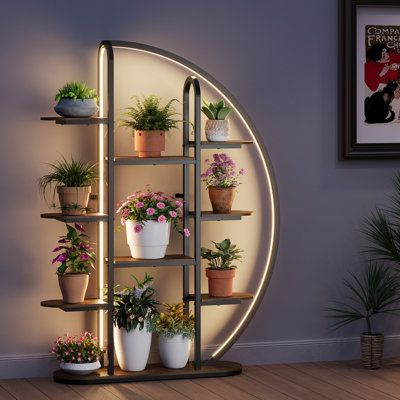 The Moon-Shaped Plant Stand stands 65" tall with 9 tiers, offering ample space to display plants while maximizing efficiency. Its unique moon-shaped design adds artistic flair to any space. Featuring a versatile 24V LED light with 5 modes and 8 brightness levels, it can be attached to the front or rear pole for optimal plant lighting. Built with a durable metal frame and 12mm waterproof particle board shelves, it resists rust and corrosion. Ideal for displaying plants or decor, it's perfect for Plant Stand For Living Room, Metal Plant Shelf, Shelf Flower, Displaying Plants, Garden Gadgets, Living Room Corner, Plant Shelf, Metal Plant Stand, Wood Plant Stand