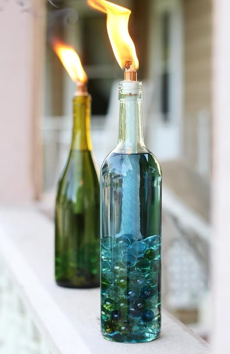 Replace your old, weathered tiki torches with beautiful, colorful DIY wine bottle citronella candles. Wine Bottle Citronella Candles, Reuse Wine Bottles, Wine Bottle Project, Empty Wine Bottles, Wine Craft, Wine Bottle Art, Wine Bottle Diy Crafts, Tiki Torches, Citronella Candles