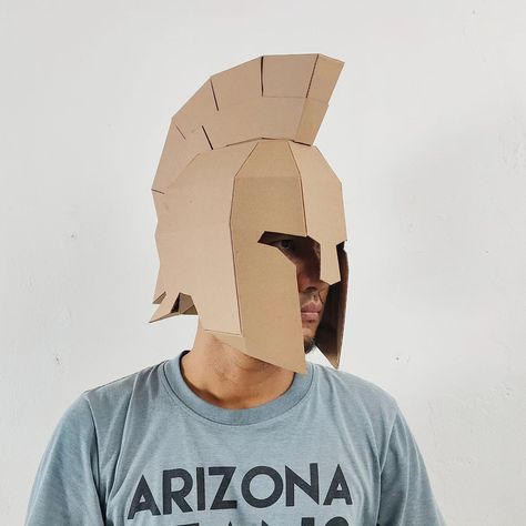 ancient greek helmet made out of cardboard. This is base form, means you can modify it into Spartan helmet, centurion, or achilles. PS. Template available on the web. check my bio Any idea what should I make next? Roman Helmet Template, Carbord Craft, Ancient Greek Helmet, Trojan Helmet, Greek Helmet, Cardboard Costume, Roman Helmet, Gladiator Helmet, Roman Centurion